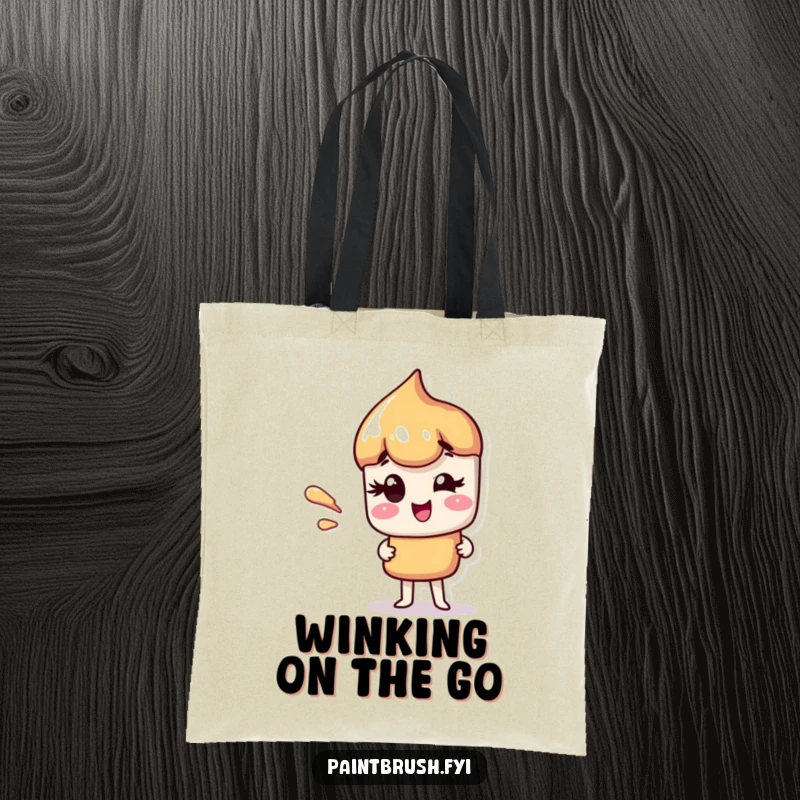 Funny tote bag with a paintbrush character giving a charming wink, featuring a dynamic paint streak.